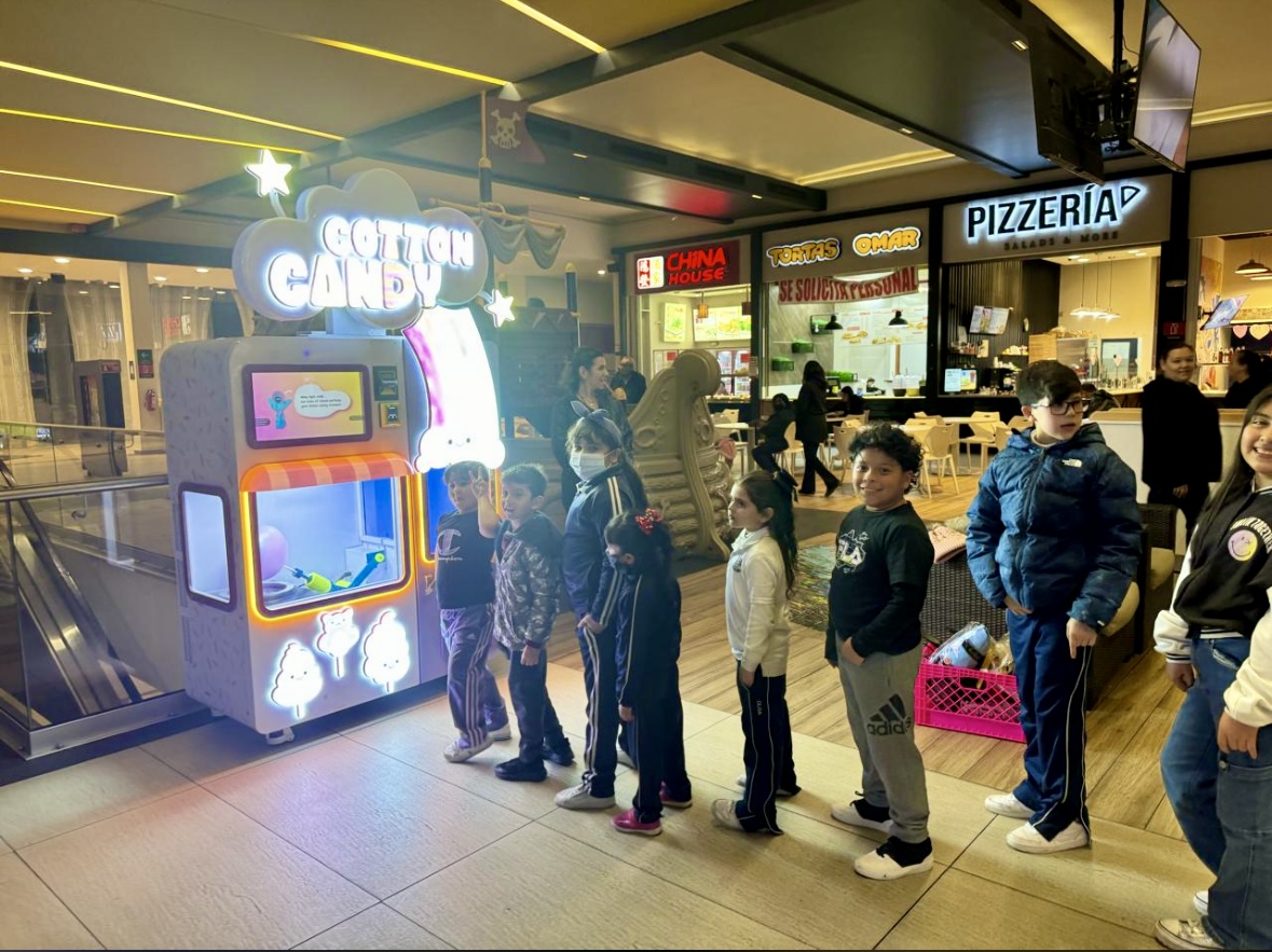 Kids lined up at cotton candy machine in mall